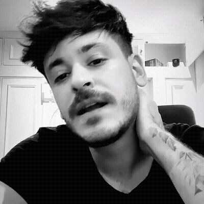 A Man With A Beard And Mustache Has A Tattoo On His Wrist GIF