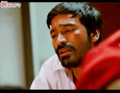 A Man With A Beard And Mustache Is Crying And Looking Down . GIF