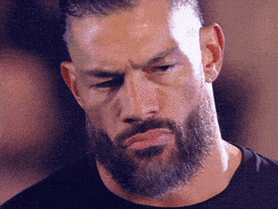 A Man With A Beard And Mustache Is Making A Funny Face . GIF