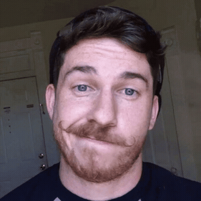 A Man With A Beard And Mustache Is Making A Funny Face GIF