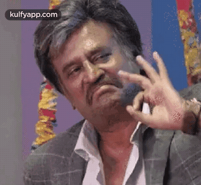 A Man With A Beard And Mustache Is Making A Funny Face With His Hands . GIF