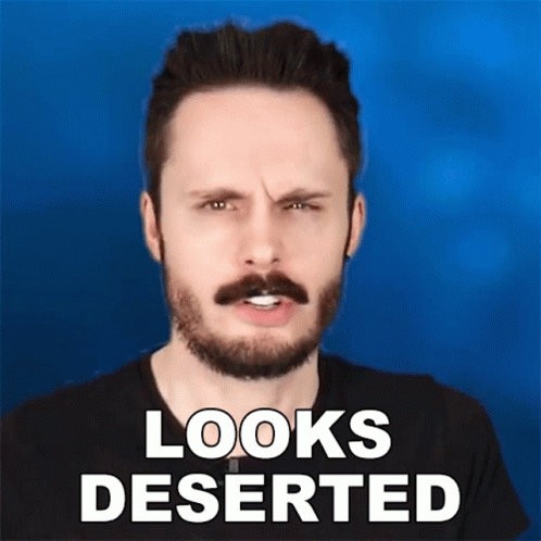 A Man With A Beard And Mustache Is Making A Funny Face With The Words Looks Deserted Below Him GIF