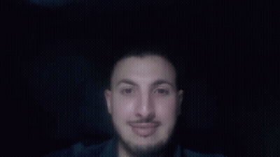 A Man With A Beard And Mustache Is Pointing Up With His Finger GIF