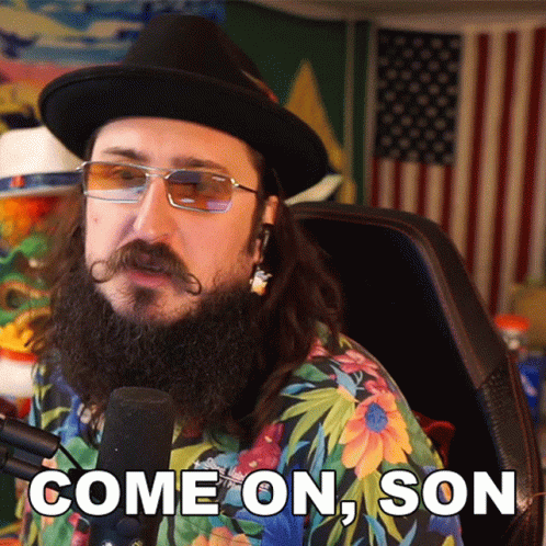 A Man With A Beard And Mustache Is Sitting In Front Of A Microphone And Says Come On Son GIF