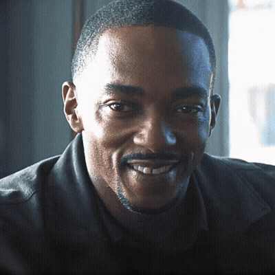 A Man With A Beard And Mustache Is Smiling GIF