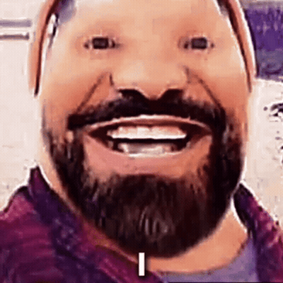 A Man With A Beard And Mustache Is Smiling And Making A Face . GIF