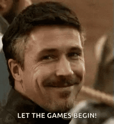 A Man With A Beard And Mustache Is Smiling And Saying `` Let The Games Begin ! '' GIF