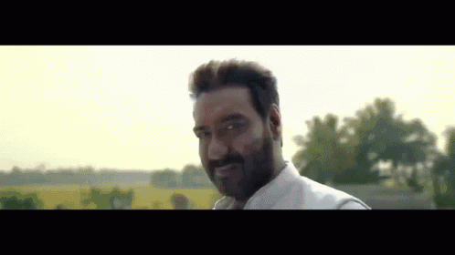 A Man With A Beard And Mustache Is Smiling For The Camera GIF