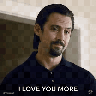 A Man With A Beard And Mustache Is Standing In Front Of A Door And Saying `` I Love You More '' . GIF