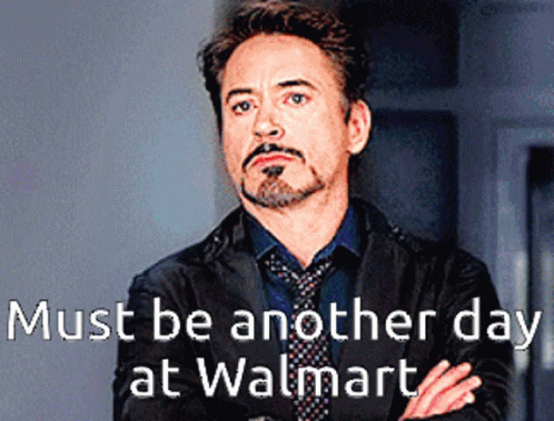 A Man With A Beard And Mustache Is Standing With His Arms Crossed In Front Of A Sign That Says Must Be Another Day GIF