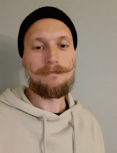 A Man With A Beard And Mustache Is Wearing A Black Hat And Giving A Thumbs Up GIF