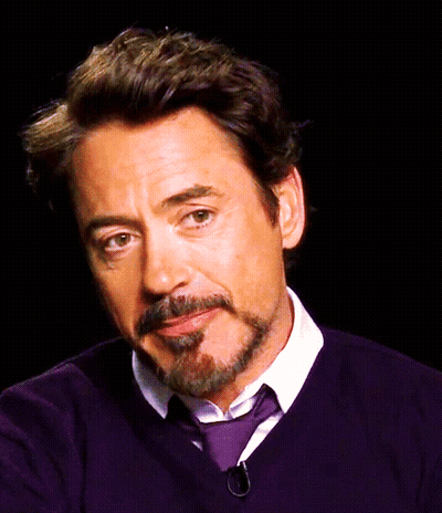 A Man With A Beard And Mustache Is Wearing A Purple Sweater And Tie GIF