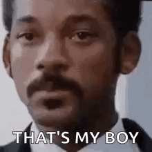 A Man With A Beard And Mustache Is Wearing A Tuxedo And A Bow Tie . GIF