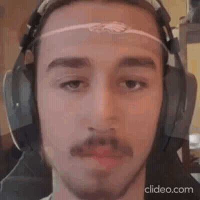 A Man With A Beard And Mustache Is Wearing Headphones . GIF