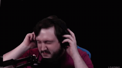 A Man With A Beard And Mustache Is Wearing Headphones In Front Of A Microphone . GIF