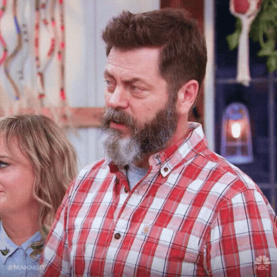 A Man With A Beard And Mustache Wearing A Plaid Shirt GIF