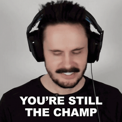A Man With A Beard And Mustache Wearing Headphones Says You 'Re Still The Champ GIF