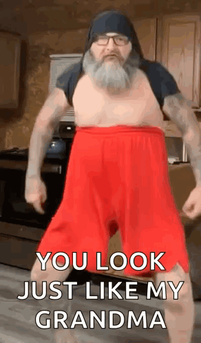 A Man With A Beard And Red Shorts Is Dancing In A Kitchen And Says `` You Look Just Like My Grandma '' . GIF