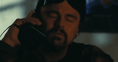 A Man With A Beard And Sunglasses Is Making A Funny Face With His Mouth Open . GIF