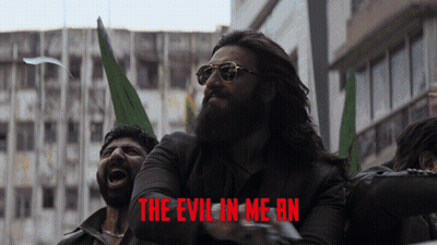A Man With A Beard And Sunglasses Is Screaming In Front Of A Poster That Says The Evil In Me An GIF