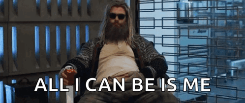A Man With A Beard And Sunglasses Is Sitting In A Chair Holding A Can Of Soda And A Can Of Soda . GIF