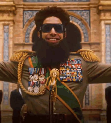 Man With Beard And Sunglasses Standing At Microphone GIF
