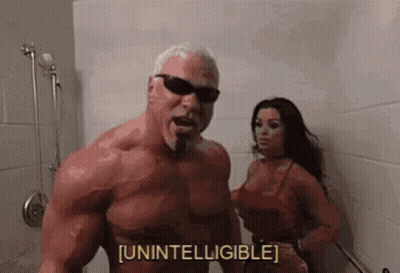 A Man With A Beard And Sunglasses Is Standing Next To A Woman In A Bathroom . GIF
