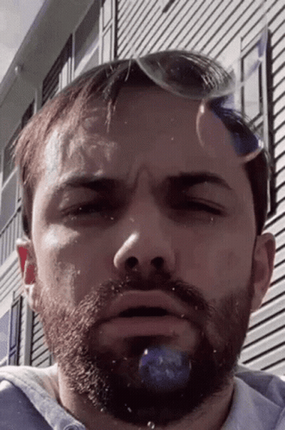 A Man With A Beard And Sunglasses On His Head Is Making A Funny Face GIF