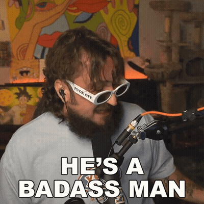 A Man With A Beard And Sunglasses Says He 'S A Badass Man In Front Of A Microphone GIF