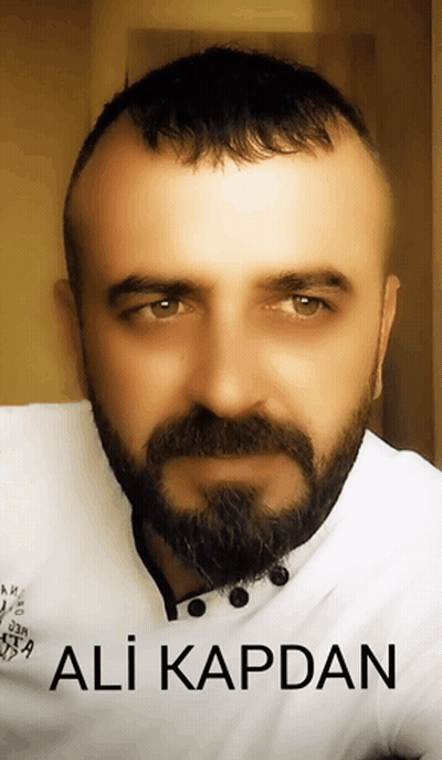 A Man With A Beard And The Name Ali Kapdan On The Bottom Right GIF