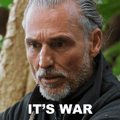 A Man With A Beard And The Words " It 'S War " On His Face GIF