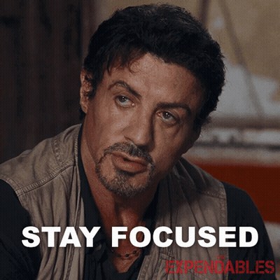 A Man With A Beard And The Words Stay Focused Behind Him GIF