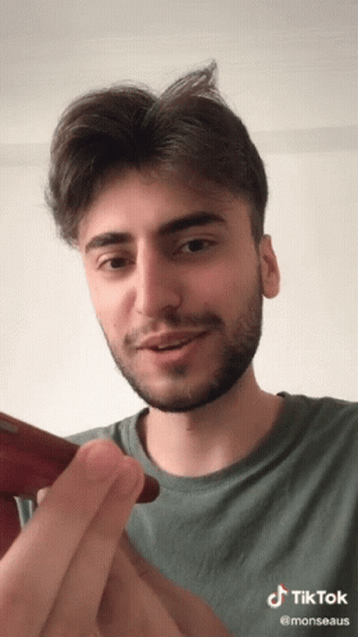 A Man With A Beard Has A Tiktok Sticker On His Face GIF