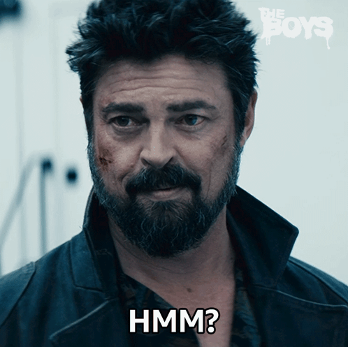 A Man With A Beard Has The Word Hmm On His Chest GIF