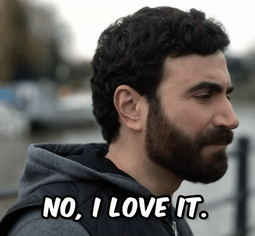 A Man With A Beard Has The Words " No I Love It " Above His Head GIF