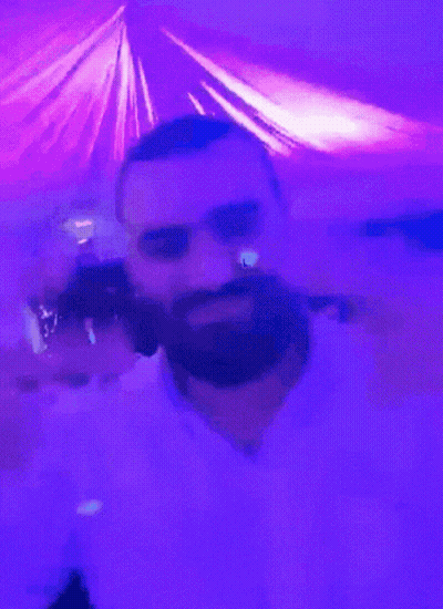 A Man With A Beard In A Purple Room GIF