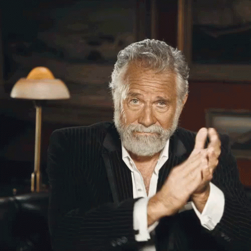 A Man With A Beard In A Suit Is Clapping His Hands GIF