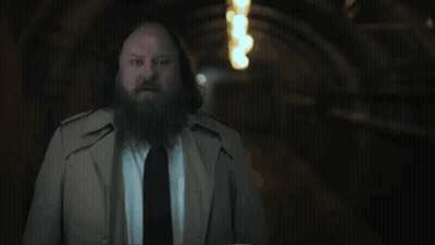 A Man With A Beard In A Trench Coat And Tie Says " That 'S What We Call A Mystery " GIF