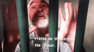 A Man With A Beard Is Behind Bars With The Words Praise Be Thy Lord The Liquor GIF