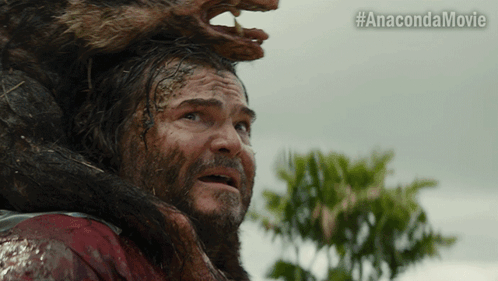 A Man With A Beard Is Being Attacked By A Monster With The Hashtag #Anacondamovie GIF