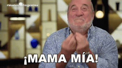 A Man With A Beard Is Clapping His Hands And Says Mama Mia GIF