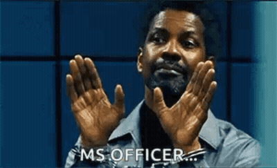 A Man With A Beard Is Clapping His Hands In A Room . GIF