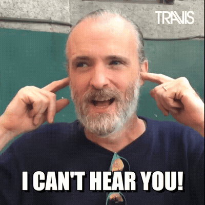 A Man With A Beard Is Covering His Ears With His Hands And Says " I Can T Hear You " GIF