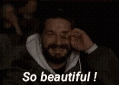A Man With A Beard Is Covering His Eyes While Watching A Movie And The Words `` So Beautiful '' Are Above Him . GIF