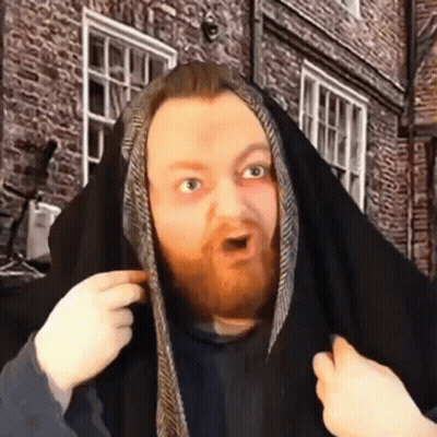 A Man With A Beard Is Covering His Head With A Black Cloth . GIF