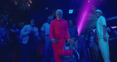 A Man With A Beard Is Dancing In A Club With A Group Of People . GIF
