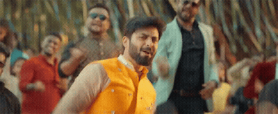 A Man With A Beard Is Dancing In Front Of A Crowd . GIF
