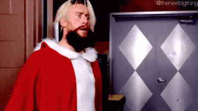 A Man With A Beard Is Dressed In A Santa Claus Costume . GIF