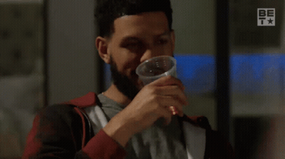 A Man With A Beard Is Drinking From A Plastic Cup And Says Too Easy . GIF