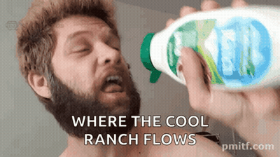 A Man With A Beard Is Drinking From A Spray Bottle With The Words " Where The Cool Ranch Flows " GIF